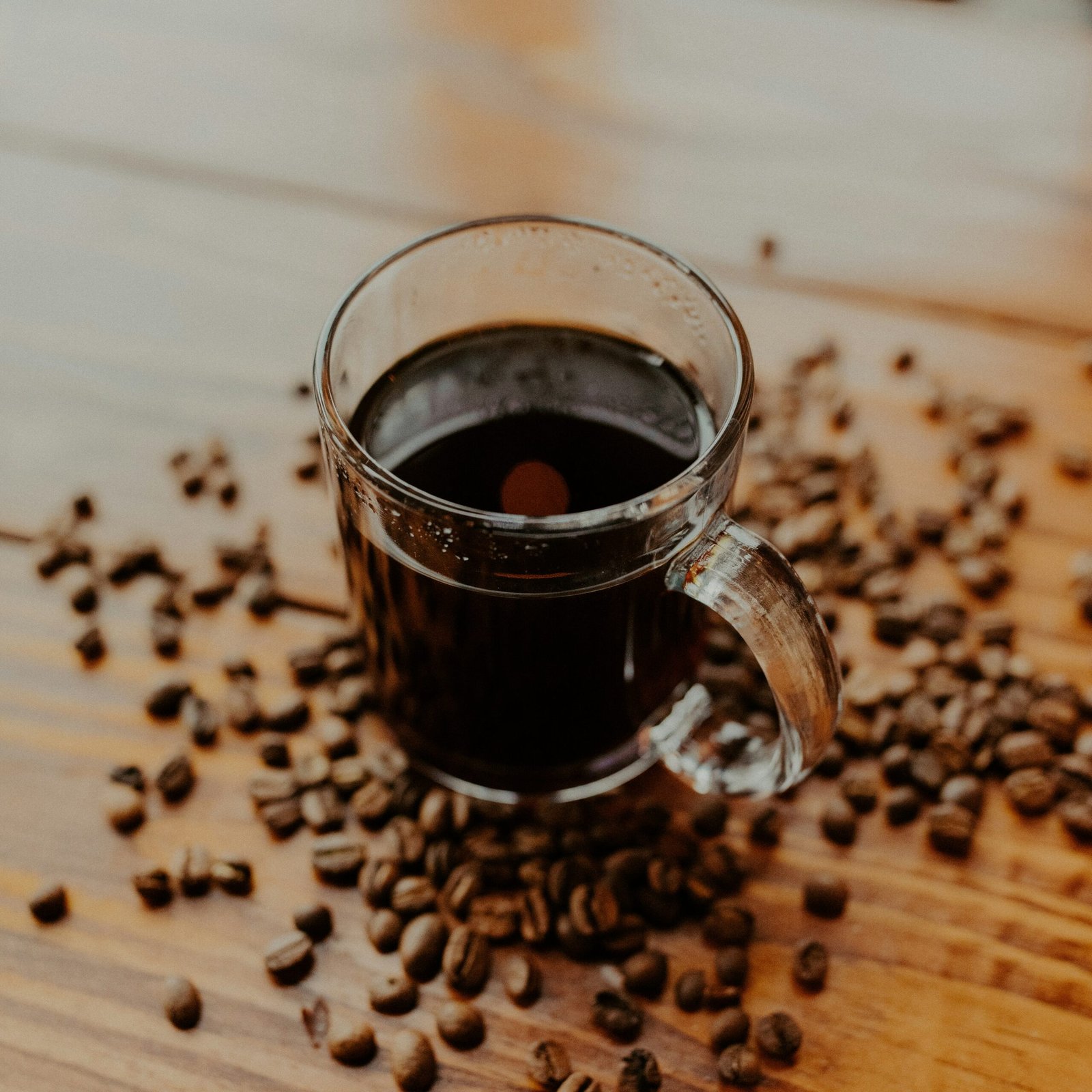 clear glass mug on brown wooden table